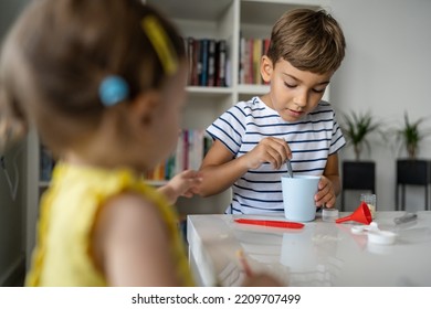 Two Kids Playing With Toys At Home One Boy Preschooler With His Little Sister Baby Girl Making Experiments Childhood Growing Up Concept