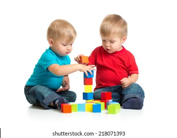 Two Kids Playing Wooden Blocks Together Building Tower
