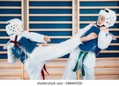 Two kids sparing on tae kwon do
