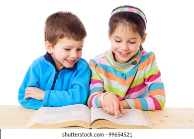 Two Kids At The Table Reading The Book, Isolated On White