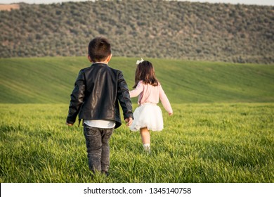 Two kids walking at meadow