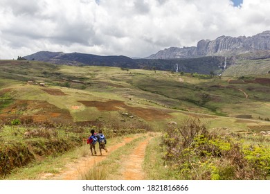 Two Kids Walking In A Valley In Front Of Legendary Waterfall Of King And Queen In Andringitra Mountains, Ambalavao District, Madagascar