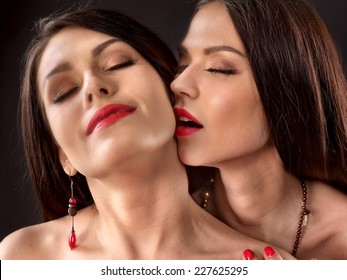 Two Kissing Lesbian Women Kissing .Black Background.