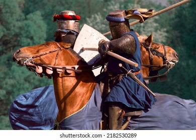 Two Knights Attack Each Other With Galloping Spears. Knightly Tournament On Horseback. Knight Duel One On One. Medieval Warfare. Close Combat.