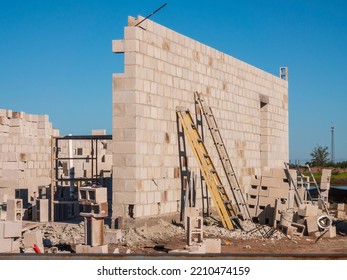 Two Ladders Lean Against New Exterior Wall Of Single-family House Under Construction In A Suburban Development On A Sunny Morning In Southwest Florida