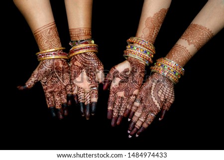 Two lady hand with indian heena mehandi in indian wedding with blur background