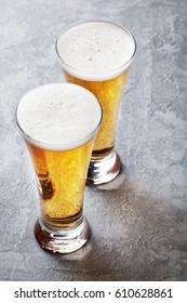 Two Lager Beer Glasses On Stone Table