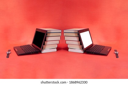 two laptop and a stack of different books