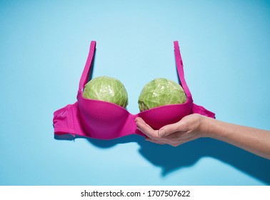 Two large cabbage in a pink bra, imitation of a large female breast.