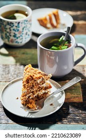 Two Large Pieces Of Cake On Honey Cakes With A Mug Of Tea With Lemon And Mint. Vertical Photo.