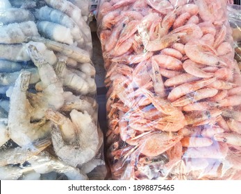 Two Large Plastic Bags Of Frozen Raw And Cooked Shrimp, On The Counter Of The Fish Market.