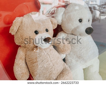 Two large teddy bears behind store window, perfect childhood symbol and toy shop display