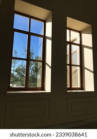  two large windows facing the outside, photographed from the inside