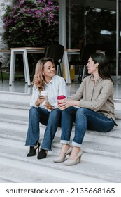 Two Latin Business Woman Middle Age, Talking And Advising Each Other At The Office In Mexico Latin America