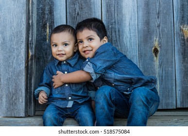 Two Latino Children Hugging On A Staircase