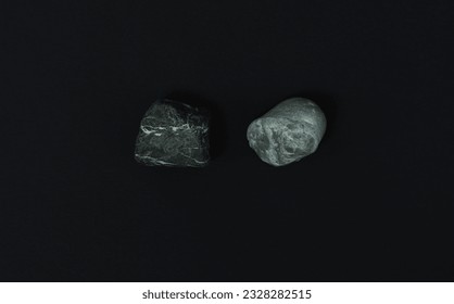 Two layered stones of heterogeneous texture, one bluish with white streaks, the other black with beige streaks in thin and wide formations. Complex texture. Macrophotograph on black background.  - Shutterstock ID 2328282515