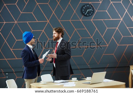 Two leaders negotiating by workplace