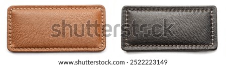 Two leather wallets with different colors. One is brown and the other is black. The brown wallet has a brown leather strap and the black wallet has a black leather strap