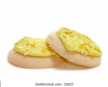 Two Lemon Iced Sugar Cookies With Sprinkles.