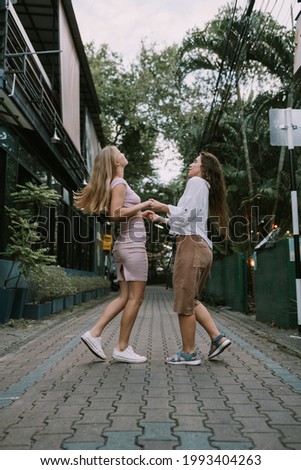 Two lesbians dancing on the street