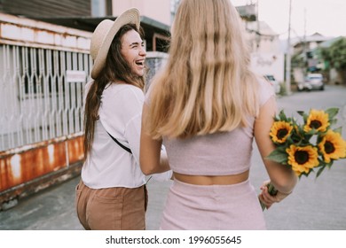 Two Lesbians Walking Down The Street Holding Hands. Summertime