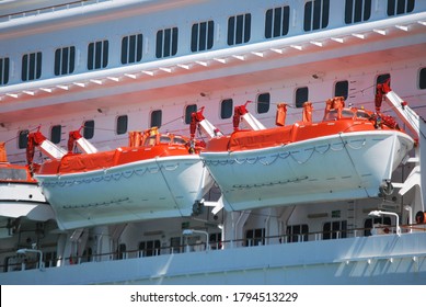 
two lifeboats on the side of a cruise ship