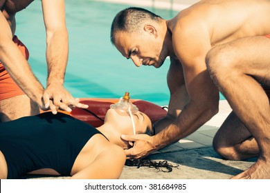 Two lifeguards in training, doing CPR. Toned image - Powered by Shutterstock