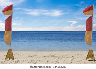 Two Lifesaving Flags On  A Tropical Beach In Australia