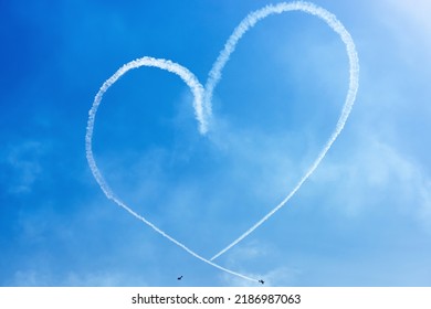 Two Light Airplanes In The Sky Writing Romantic Heart Shape - Powered by Shutterstock