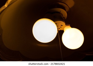 Two Light Bulbs That Glow In A Dark Room