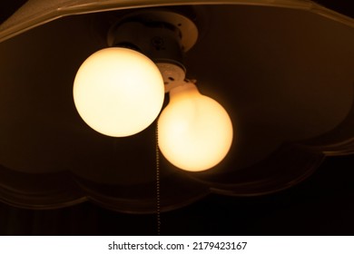 Two Light Bulbs That Glow In A Dark Room