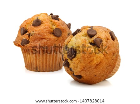 Two light chocolate chip muffins in wax liner on white.