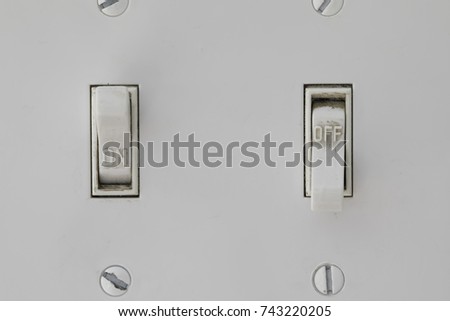 Two Light Switches with the left one on and the right off