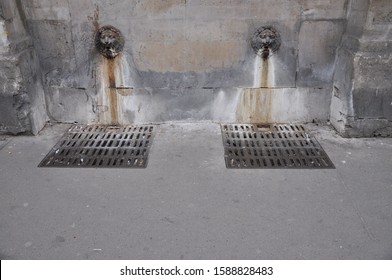 Two Lion Heads Sewer Pipes On The Streets Of Paris