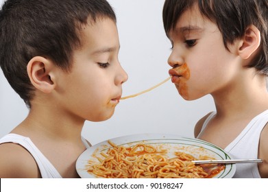 Two Little Boys Eating Spaghetti Against Each Other