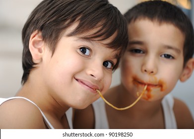 Two Little Boys Eating Spaghetti