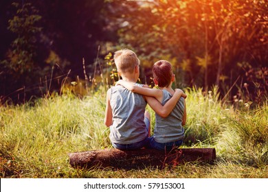 Two Little Boys Friends Hug Each Other In Summer Sunny Day. Brother Love. Concept Friendship. Back View.