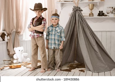 Two Little Boys In The Image Of Cowboys And Indians Play In His Room