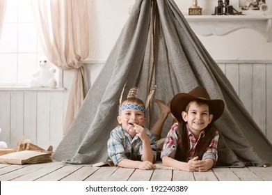 Two Little Boys In The Image Of Cowboys And Indians Play In His Room