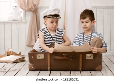 Two little boys in the image of sailors playing in her room 