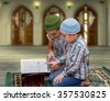 boy reading quran isolated