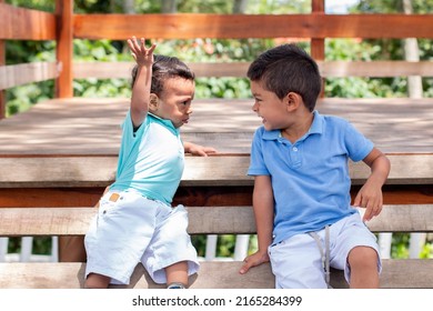 Two Little Boys Playing, Arguing And Laughing. Little Brothers Dressed In Matching Colors.