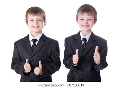 two little boys twins in business suits thumbs up isolated on white background