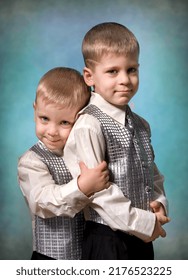 Two little brothers in silvery waistcoat posing in the studio - Shutterstock ID 2176523225