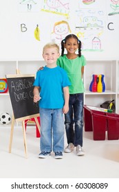 Two Little Classmates In Preschool Classroom