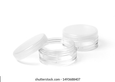 Two little empty colorless transparent plastic container for cosmetic products. Image with clipping path.