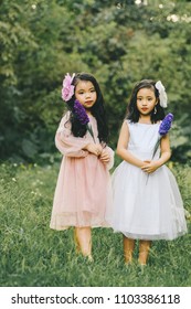 Two little girls in a beautiful dress in a park at sunset in Hanoi, Vietnam.