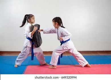 Two little girls demonstrate martial arts working together. Fighting position, active lifestyle, practicing fighting techniques