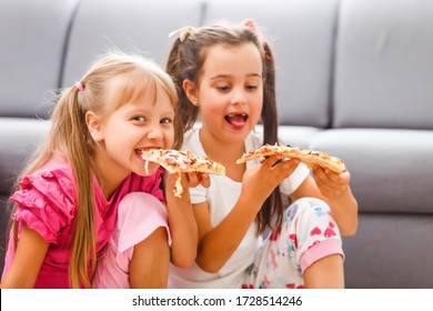 Two Little Girls Eating Huge Pizza At Home