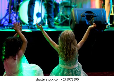 Two Little Girls In Front Of Stage During Rock Concert